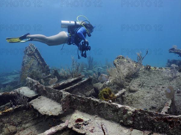 Diver swimming over the wreck of the Benwood. Dive site John Pennekamp Coral Reef State Park, Key Largo, Florida Keys, Florida, USA, North America