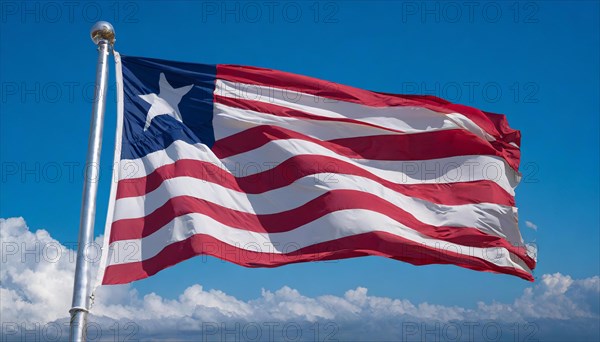 The flag of Liberia, fluttering in the wind, isolated, against the blue sky