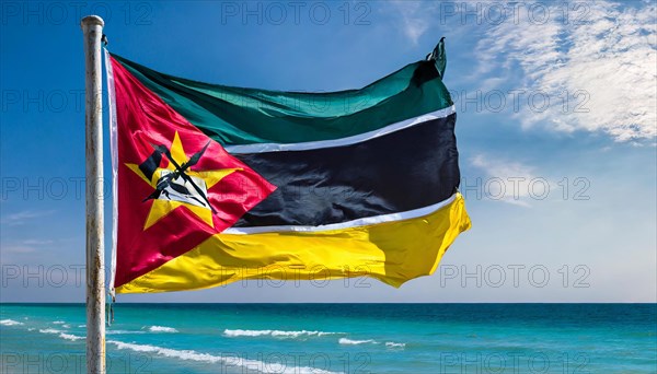 The flag of Mozambique, fluttering in the wind, isolated, against the blue sky