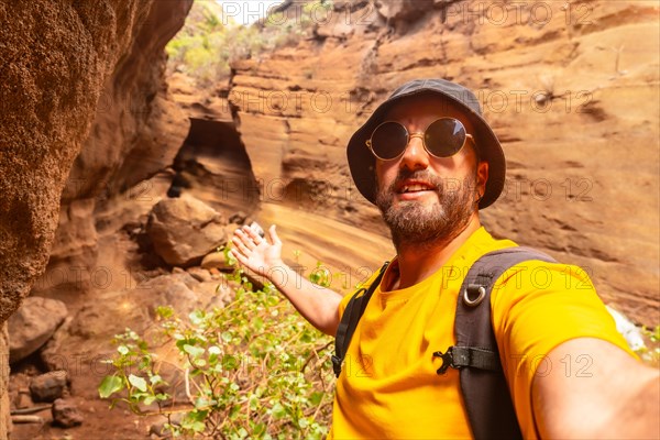 Selfie of a man enjoying in the limestone canyon Barranco de las Vacas in Gran Canaria, Canary Islands