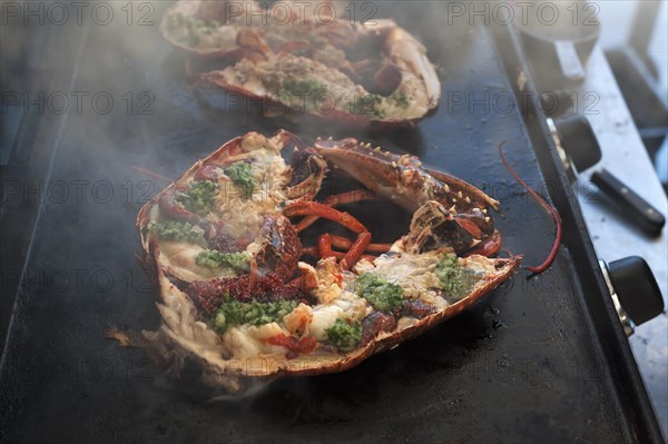 Cooked lobster (homarus) with caviar, vegetables and garlic butter on a plancha, Atlantic coast, Vandee, France, Europe