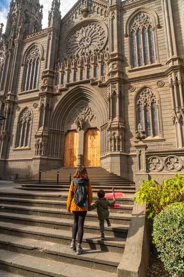 A mother with her son visiting the Church of San Juan Bautista, Arucas Cathedral, Gran Canaria, Spain, Europe