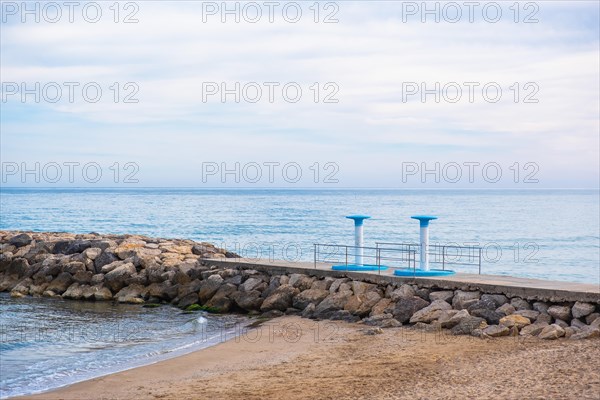 Showers on the beach in Sitges, Spain, Europe