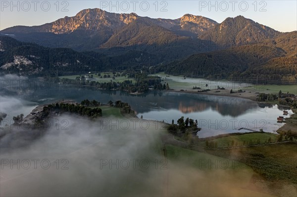 Aerial view of a mountain lake, mountains reflected in the lake, morning light, fog, summer, Lake Kochel, foothills of the Alps, Bavaria, Germany, Europe