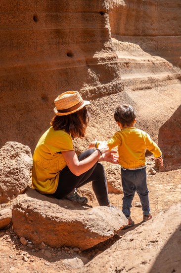 Family enjoying in the limestone canyon Barranco de las Vacas in Gran Canaria, Canary Islands