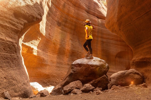 Adventurous tourist woman in the limestone canyon Barranco de las Vacas in Gran Canaria, Canary Islands