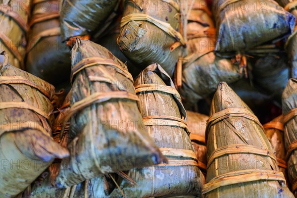 Excursion to Zhujiajiao Water Village, Shanghai, China, Asia, A collection of traditionally wrapped rice parcels surrounded by leaves, Asia