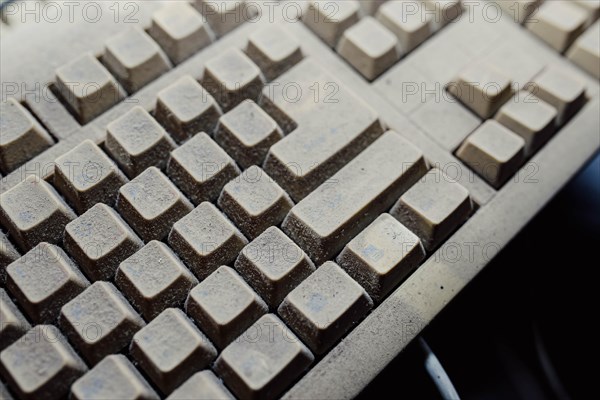 Old vintage computer mechanical keyboard in dust, computer keyboard from the 1980s