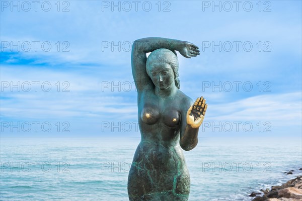 Bust of a siren or mermaid with worn hands and breasts in Sitges, Spain, Europe