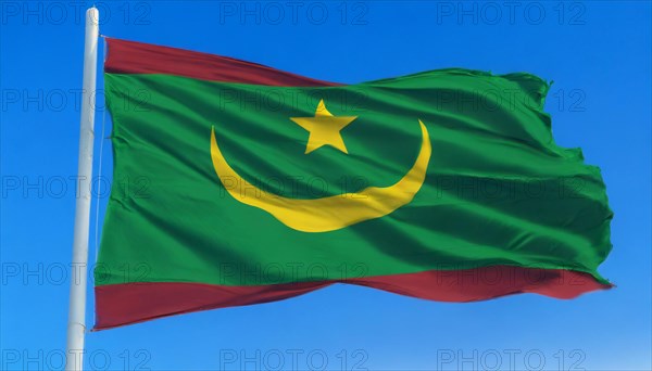 The flag of Mauritania, Mauritania, flutters in the wind, isolated against a blue sky, Africa