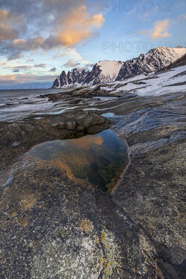 Rocky coast in front of Bergen, sea and pond, morning mood with clouds, winter, Tungeneset, Senja, Troms, Norway, Europe