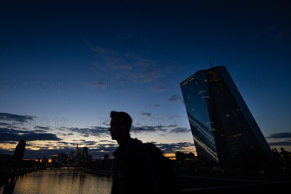 The remaining light of day is reflected in the glass facade of the European Central Bank (ECB) in Frankfurt am Main, Frankfurt am Main, Hesse, Germany, Europe