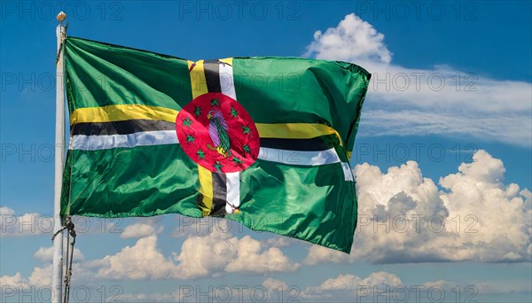 The flag of Dominica, Lesser Antilles, Caribbean, fluttering in the wind, isolated, against the blue sky
