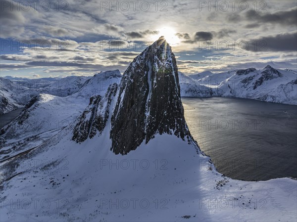 Aerial view of Bergen by the sea, fjord, sunbeams, winter, snow, Mount Segla, Senja, Troms, Norway, Europe