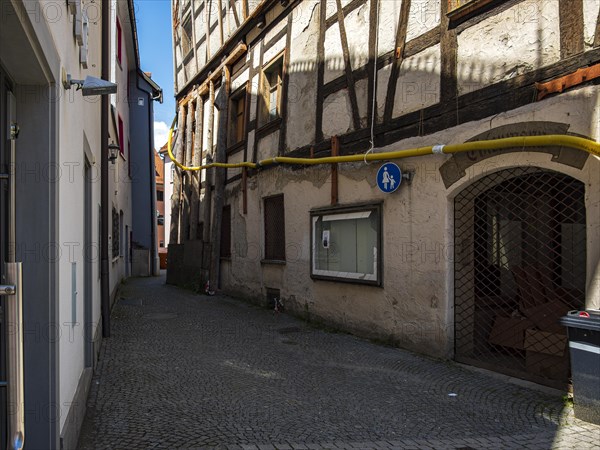 View through the Trinklaube, a winding narrow alley in the old town of Wangen im Allgaeu, Upper Swabia, Baden-Wuerttemberg, Germany, Europe