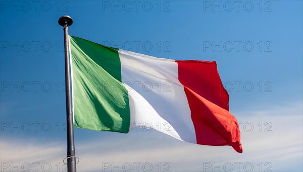 The flag of Italy flutters in the wind, isolated against a blue sky