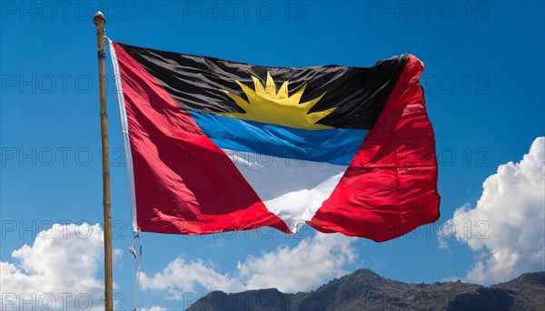 The flag of Antigua flutters in the wind, isolated against the blue sky