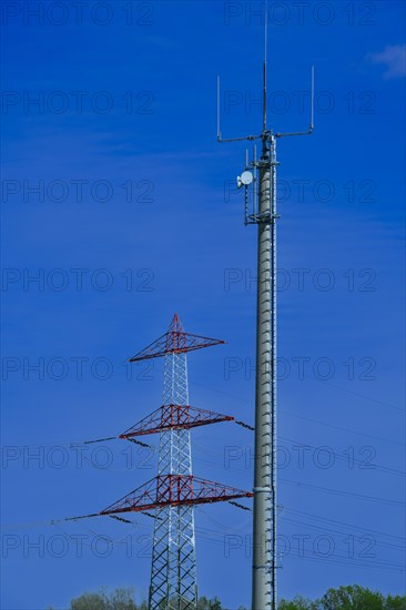 Electricity pylon with high-voltage lines and mobile phone mast near the Avacon substation Helmstedt, Helmstedt, Lower Saxony, Germany, Europe