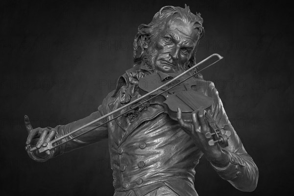 Detailed view on dark background, bronze statue of the violinist Niccolo Paganini by the artist Niccolo Tommaseo, entrance hall of the Teatro Carlo Felice, Passo Eugenio Montale, 4, Genoa, Italy, Europe