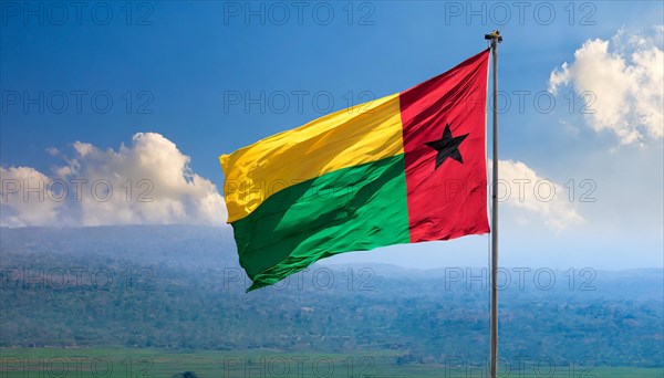 The flag of Guinea-Bissau, fluttering in the wind, isolated, against the blue sky