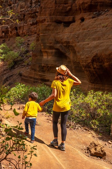 A woman with her child in the limestone canyon Barranco de las Vacas on Gran Canaria, Canary Islands