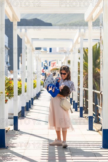 A mother with her son playing on holiday in Puerto de Las Nieves in Agaete on Gran Canaria, Spain, Europe