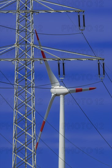 Power pylon with high-voltage lines and wind turbines at the Avacon substation Helmstedt, Helmstedt, Lower Saxony, Germany, Europe