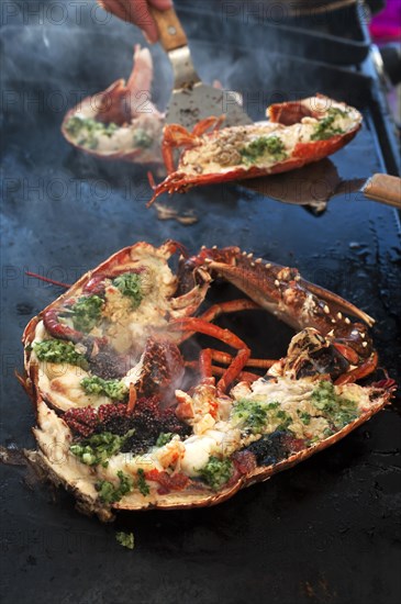 Cooked lobster (homarus) with caviar, vegetables and garlic butter on a plancha, Atlantic coast, Vandee, France, Europe