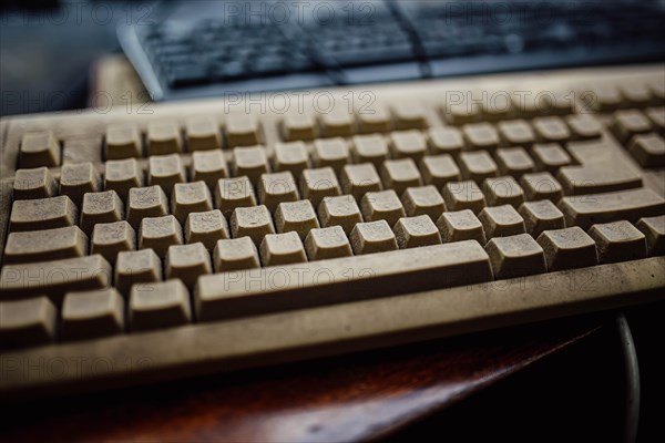 Old vintage computer mechanical keyboard in dust, computer keyboard from the 1980s