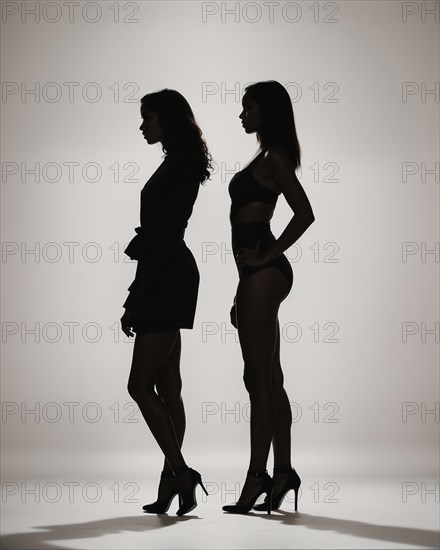 Silhouette of three women in black and white dresses, studio shot. ai generative, AI generated