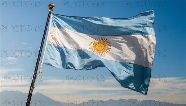 The flag of Argentina flutters in the wind, isolated against a blue sky