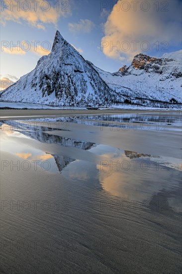 Steep mountain reflected in the water on the beach, coast, morning mood with clouds, winter, Senja, Troms, Norway, Europe
