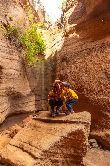 Family on vacation in the limestone canyon Barranco de las Vacas on Gran Canaria, Canary Islands