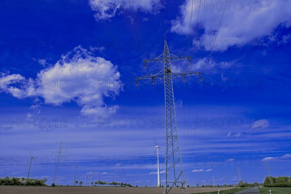 Power pylons with high-voltage lines and wind turbines at the Avacon substation in Helmstedt, Helmstedt, Lower Saxony, Germany, Europe