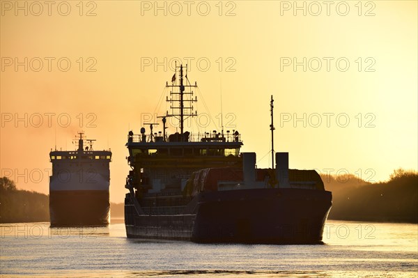 Shipping traffic, cargo ship at sunrise in the Kiel Canal, Kiel Canal, Schleswig-Holstein, Germany, Europe