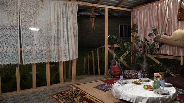 Interior of a rustic cottage with a guitar on the table