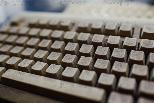 Old vintage computer mechanical keyboard in dust, computer keyboard from the 1980s