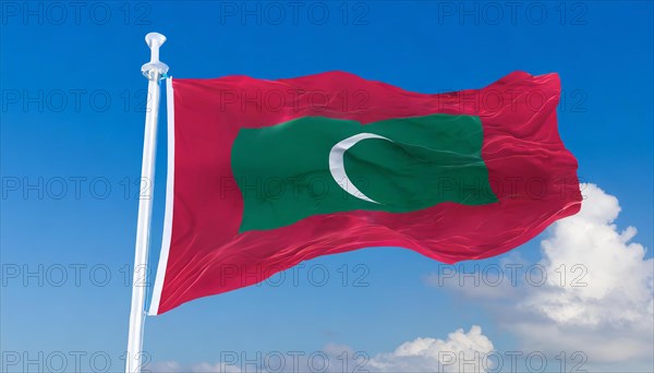 The flag of Maldives, fluttering in the wind, isolated, against the blue sky
