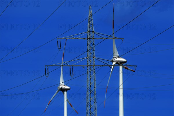 Power pylon with high-voltage lines and wind turbines at the Avacon substation Helmstedt, Helmstedt, Lower Saxony, Germany, Europe