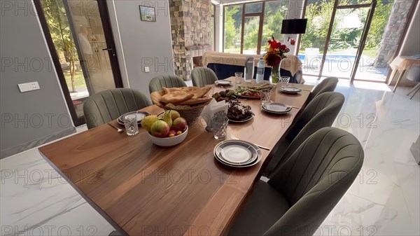 Interior of a modern dining room with wooden table and chairs