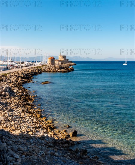 Mandraki port and bay in Rhodes. Historic windmills in the background