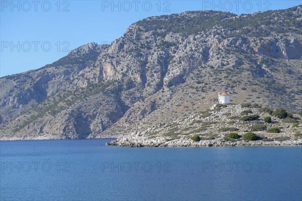 Old windmill on a rock, Bay of Panormitis, Symi, Dodecanese, Greece, Europe