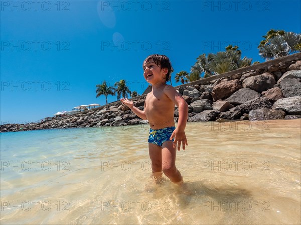 Child on vacation on a beach in the Canary Islands. Concept of happy family outdoors. Family vacation on the sea coast