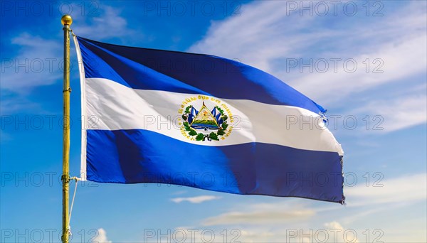 The flag of El Salvador flutters in the wind, isolated against a blue sky