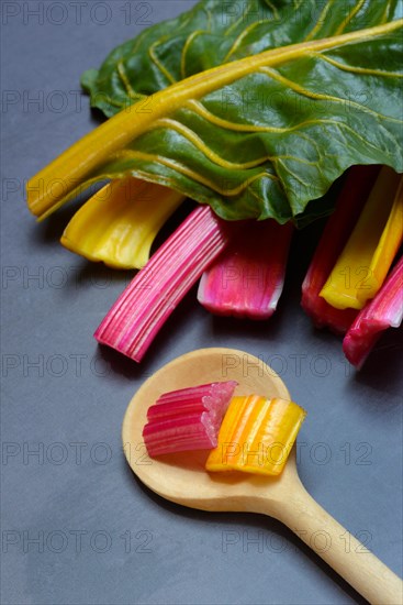 Red and yellow chard, wooden spoon and chopped stems, Beta vulgaris