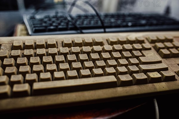 Old vintage computer mechanical keyboard in dust, computer keyboard from the 1980s