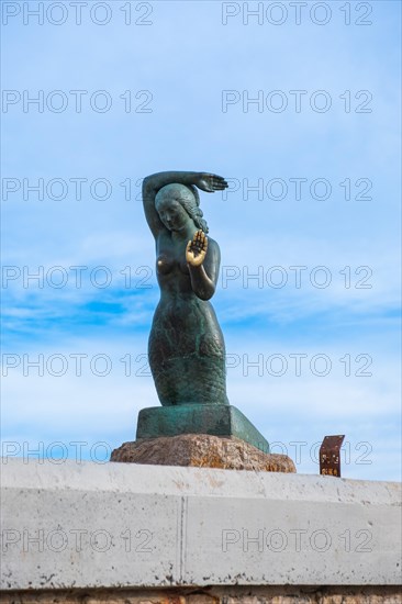 Bust of a siren or mermaid with worn hands and breasts in Sitges, Spain, Europe