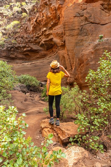 A woman tourist in the limestone canyon Barranco de las Vacas in Gran Canaria, Canary Islands