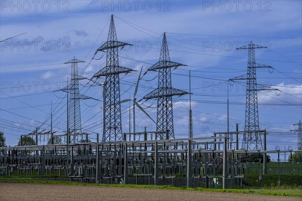 Power pylons with high-voltage lines and wind turbine at the Avacon substation in Helmstedt, Helmstedt, Lower Saxony, Germany, Europe