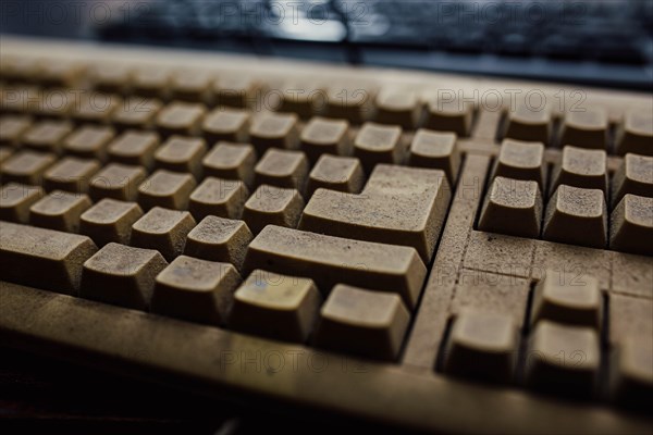 Old vintage computer mechanical keyboard in dust, computer keyboard from the 1980s